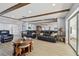 Spacious living room boasts wood beam ceilings, tile floors, and open floorplan at 2970 68Th S Ave, St Petersburg, FL 33712