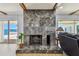 Living room featuring a large marble fireplace with a hearth and sliding glass doors with a waterfront view at 2970 68Th S Ave, St Petersburg, FL 33712