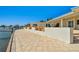 View of home from the water featuring a beige paver patio leading to a private boat dock at 2970 68Th S Ave, St Petersburg, FL 33712