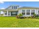 Manicured backyard with lush lawn and beautifully landscaped garden at 31651 Westbury Estates Ave, Wesley Chapel, FL 33545
