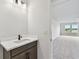 Powder room featuring sleek vanity and view of bedroom at 31651 Westbury Estates Ave, Wesley Chapel, FL 33545