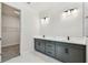 Bright bathroom features a double sink vanity with modern fixtures and leads to a walk-in closet at 31651 Westbury Estates Ave, Wesley Chapel, FL 33545