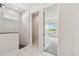 This ensuite bathroom features a walk-in shower and an open doorway with a view of the bedroom at 31651 Westbury Estates Ave, Wesley Chapel, FL 33545