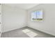 Well-lit bedroom with plush carpeting and a window offering a scenic view at 31651 Westbury Estates Ave, Wesley Chapel, FL 33545