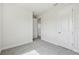 Spacious bedroom with neutral carpet and trim and view into another room at 31651 Westbury Estates Ave, Wesley Chapel, FL 33545