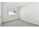 Well-lit bedroom with plush carpeting and a window at 31651 Westbury Estates Ave, Wesley Chapel, FL 33545