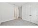 Spacious bedroom with plush carpeting and view into hallway at 31651 Westbury Estates Ave, Wesley Chapel, FL 33545