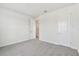 Spacious bedroom with carpeted floors and an open doorway to a closet providing ample storage at 31651 Westbury Estates Ave, Wesley Chapel, FL 33545