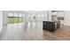 Modern kitchen showcasing an island, stainless appliances, and sliding glass doors with a view of the lake at 31651 Westbury Estates Ave, Wesley Chapel, FL 33545