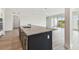 Kitchen island featuring granite countertop and a sink at 31651 Westbury Estates Ave, Wesley Chapel, FL 33545