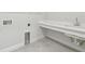 Bright laundry room with sink, countertop, tile flooring, and washer/dryer hookups at 31651 Westbury Estates Ave, Wesley Chapel, FL 33545