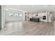 Spacious open floor plan with natural light and wood-look flooring at 31651 Westbury Estates Ave, Wesley Chapel, FL 33545