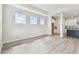 Bright living room with multiple windows, white walls, and wood-look flooring at 31651 Westbury Estates Ave, Wesley Chapel, FL 33545