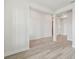 Spacious living area featuring wood flooring, bright white walls, and well-placed electrical outlets for convenience at 31651 Westbury Estates Ave, Wesley Chapel, FL 33545