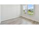 Bright room with wood flooring and large window providing natural light and neighborhood views at 31651 Westbury Estates Ave, Wesley Chapel, FL 33545