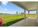 Covered patio overlooking fenced-in yard with stunning lake views at 31651 Westbury Estates Ave, Wesley Chapel, FL 33545