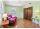 Bright bedroom with wood floors, a ceiling fan, a closet, and natural light from a window at 33357 Westwood Dr, Ridge Manor, FL 33523