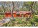 Charming house with mature trees and landscaping enhancing its curb appeal at 33357 Westwood Dr, Ridge Manor, FL 33523