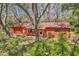 Home with mature trees and landscaping in the front yard at 33357 Westwood Dr, Ridge Manor, FL 33523