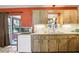 The kitchen features wood cabinets, modern appliances, under cabinet lighting, and a sliding glass door to lanai at 33357 Westwood Dr, Ridge Manor, FL 33523
