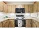 This kitchen features wood cabinets, modern appliances, and under cabinet lighting at 33357 Westwood Dr, Ridge Manor, FL 33523