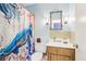 Quaint bathroom featuring a tiled shower and decorative mirror at 33357 Westwood Dr, Ridge Manor, FL 33523