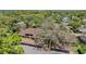 Aerial view of a multi-Gathering building with mature trees and covered parking spots at 3610 Magnolia Ridge Cir # 1322/H, Palm Harbor, FL 34684