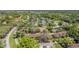 Expansive aerial view of a neighborhood with mature trees, homes, and winding roads at 3610 Magnolia Ridge Cir # 1322/H, Palm Harbor, FL 34684