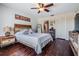 Cozy bedroom with a wooden headboard, hardwood floors, and natural light, offering a serene retreat at 3610 Magnolia Ridge Cir # 1322/H, Palm Harbor, FL 34684