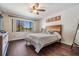 Comfortable bedroom featuring hardwood floors, a ceiling fan, and a large window with natural light at 3610 Magnolia Ridge Cir # 1322/H, Palm Harbor, FL 34684