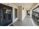 A well-lit exterior entrance with a sturdy black front door, a welcome mat, and a window showing interior spaces at 3610 Magnolia Ridge Cir # 1322/H, Palm Harbor, FL 34684