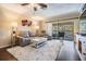 Bright living room featuring a cozy seating arrangement, stylish rug, and sliding doors to a private balcony at 3610 Magnolia Ridge Cir # 1322/H, Palm Harbor, FL 34684