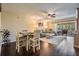 Inviting living space with wood floors, ceiling fan, and sliding glass doors providing natural light and balcony access at 3610 Magnolia Ridge Cir # 1322/H, Palm Harbor, FL 34684