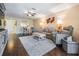 Open concept living area with wood flooring, neutral walls, and a dining area providing a comfortable living space at 3610 Magnolia Ridge Cir # 1322/H, Palm Harbor, FL 34684