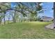 A large grassy yard with mature trees and a view of the building at 367 Bobby Jones Rd # 367, Sarasota, FL 34232