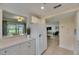 Open-concept kitchen with white appliances, cabinets, and a view to the dining and living areas at 367 Bobby Jones Rd # 367, Sarasota, FL 34232