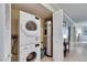 Well-organized laundry area with modern stacked washer and dryer, adjacent to a water heater for added convenience at 367 Bobby Jones Rd # 367, Sarasota, FL 34232