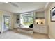 A comfy window seat is flanked by built in shelves in this bright living room at 367 Bobby Jones Rd # 367, Sarasota, FL 34232