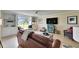 A comfy window seat is flanked by built in shelves in this bright living room at 367 Bobby Jones Rd # 367, Sarasota, FL 34232