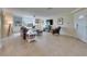Spacious living room with tile floors, a brown leather sofa, and built-in shelves at 367 Bobby Jones Rd # 367, Sarasota, FL 34232