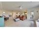 Open living room with tan tiled floors, leather sofas, and many windows at 367 Bobby Jones Rd # 367, Sarasota, FL 34232