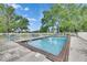 Community pool with a white fence, lounge chairs, and a clear blue sky at 367 Bobby Jones Rd # 367, Sarasota, FL 34232