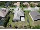 Aerial view of the home, highlighting its tile roof, screened-in patio, and fenced backyard at 5409 Conch Shell Pl, Apollo Beach, FL 33572