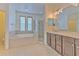Luxurious bathroom with a soaking tub, separate shower, double vanity, and ample counter space at 5409 Conch Shell Pl, Apollo Beach, FL 33572