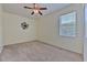 Clean bedroom featuring carpet, ceiling fan, window with blinds, and neutral walls, creating a versatile space at 5409 Conch Shell Pl, Apollo Beach, FL 33572