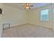 Clean, empty bedroom featuring carpet flooring, a ceiling fan, window with blinds, baseboard, and neutral walls at 5409 Conch Shell Pl, Apollo Beach, FL 33572