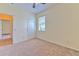Bright bedroom with neutral carpeting, a ceiling fan, and a window for natural light at 5409 Conch Shell Pl, Apollo Beach, FL 33572