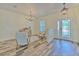 The living room features wood-look tile floors, an elegant front door, and cream walls at 5409 Conch Shell Pl, Apollo Beach, FL 33572