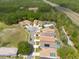An aerial view showcases the neighborhood's layout with cul-de-sac homes and a backdrop of lush trees at 5664 Legend Hills Ln, Spring Hill, FL 34609