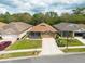 Aerial view of a home with a manicured lawn and a two-car garage at 5664 Legend Hills Ln, Spring Hill, FL 34609